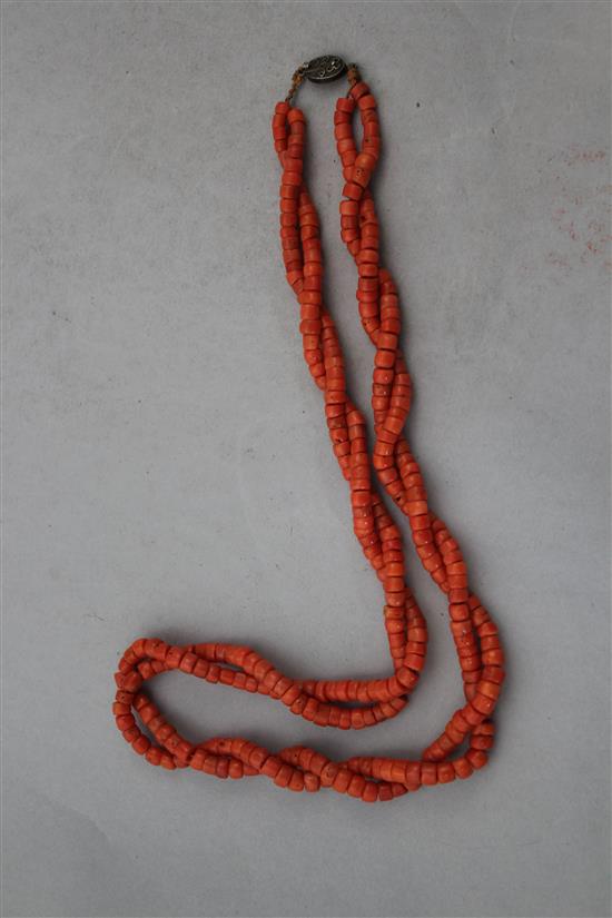 A Chinese double strand coral bead necklace, 24in.